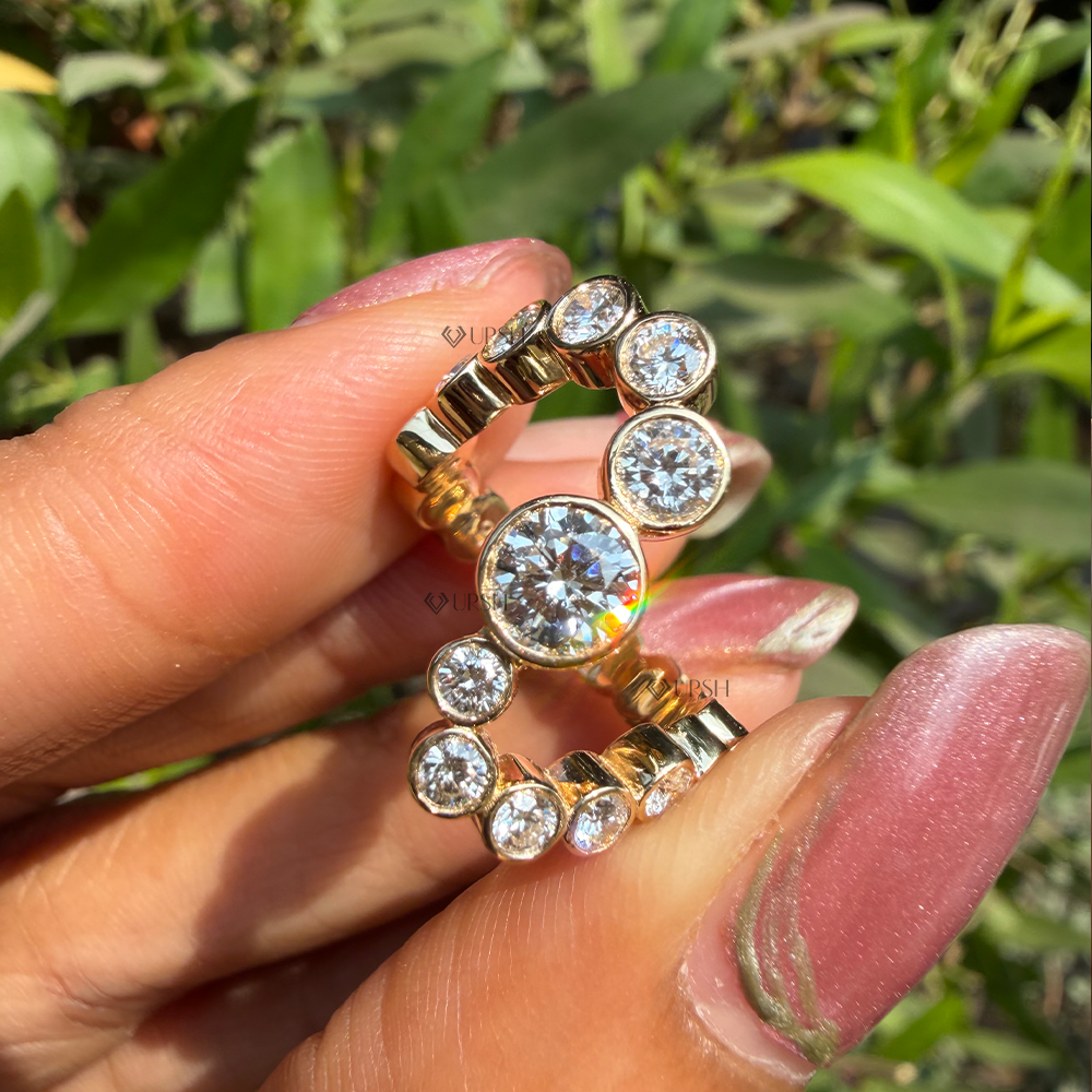 Close-up holding yellow gold snake bypass ring showcasing prominent center stone and curved flow