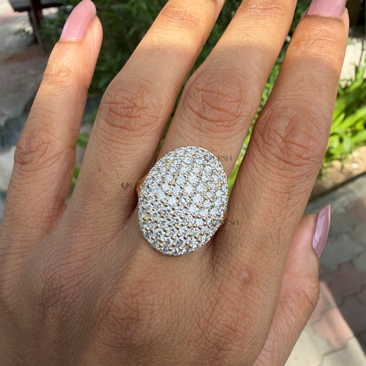 Oversized oval pavé diamond cocktail ring worn on index finger in natural daylight