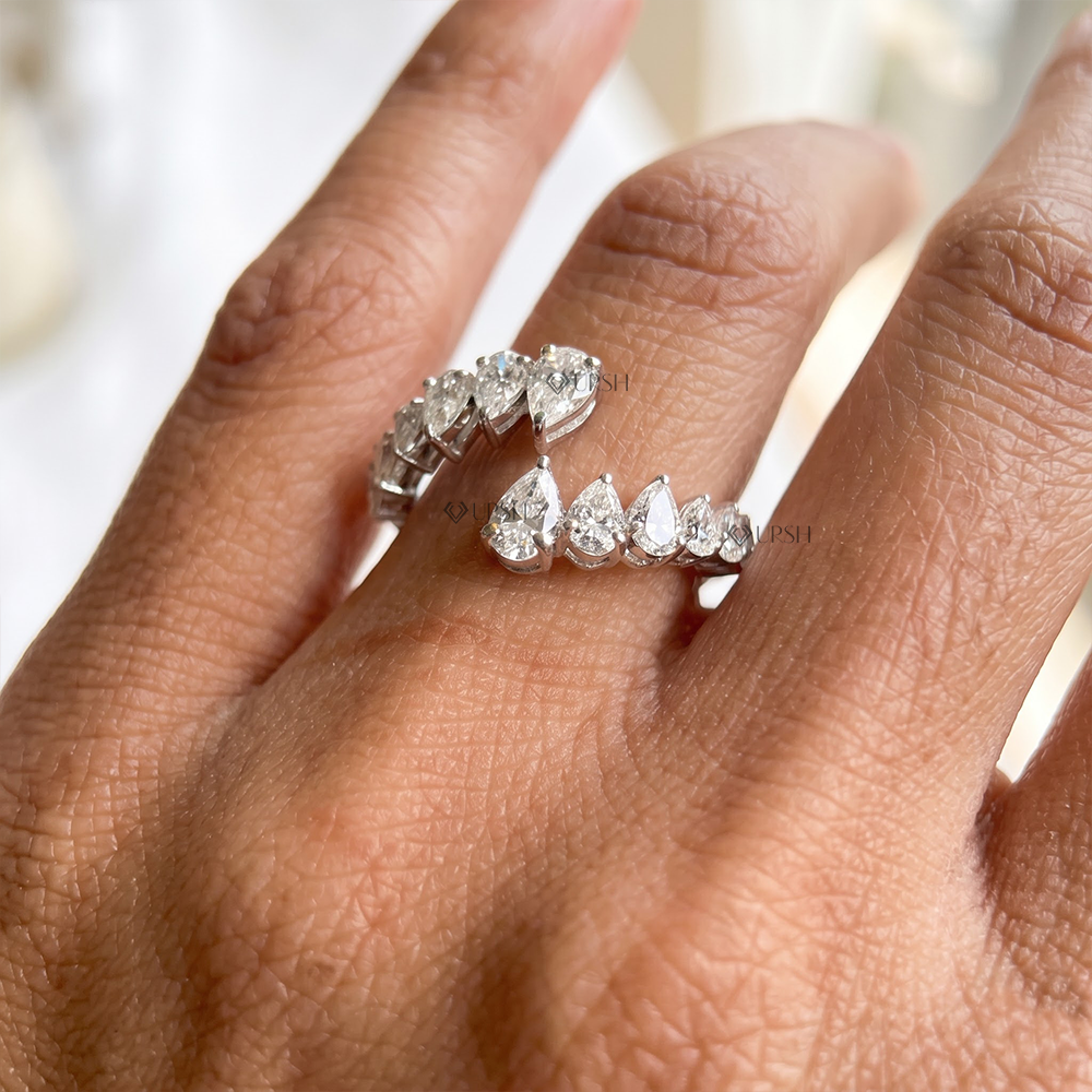 Solid white gold graduated pear cut diamond bypass spiral ring worn on hand
