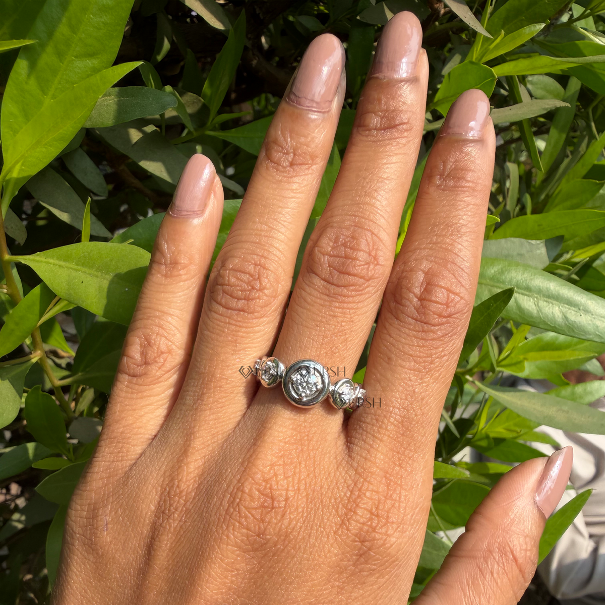 Striking multi-stone bezel station ring worn on hand showcasing bold architectural proportions.