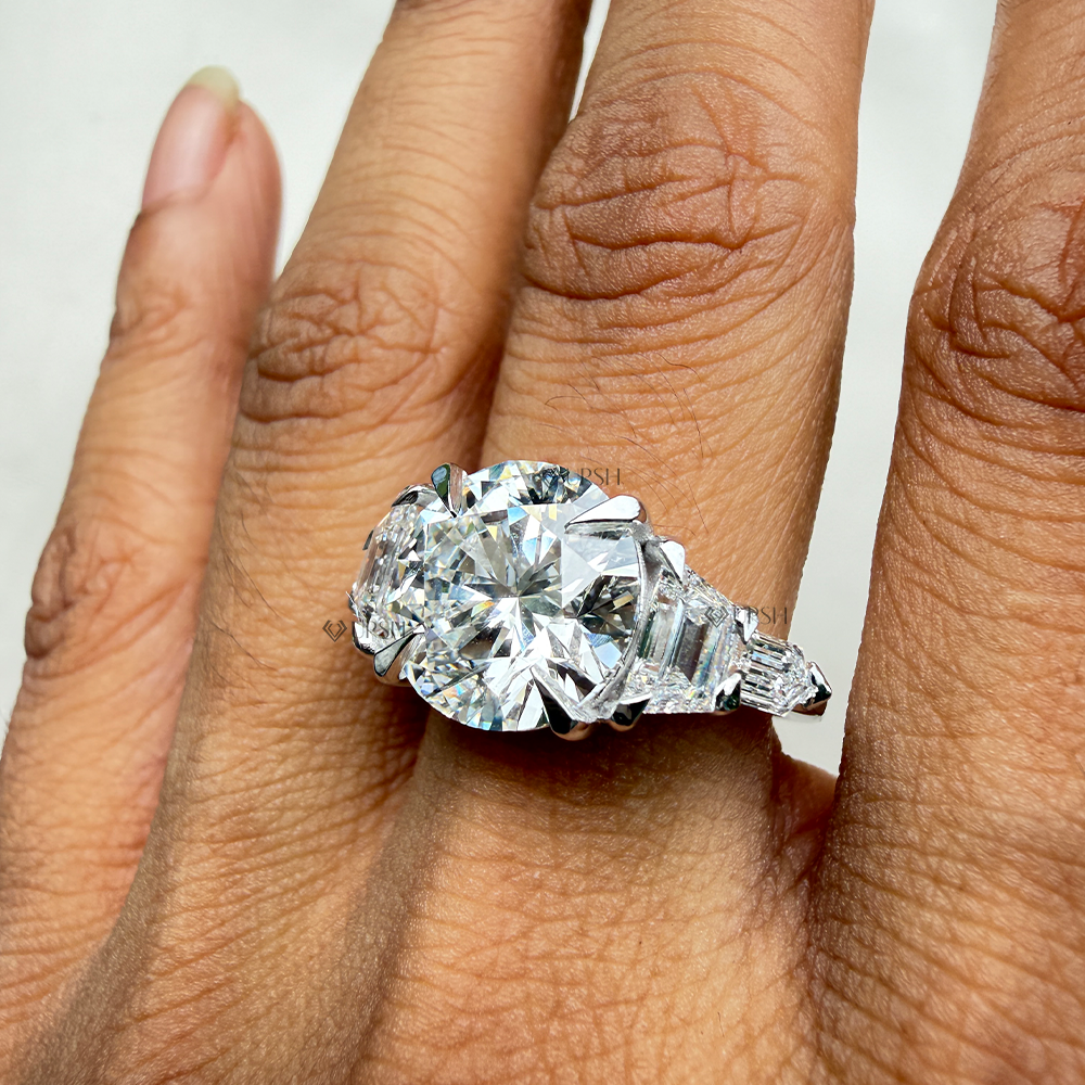 Graduated multi-stone bullet and trapezoid diamond engagement ring styled gracefully on hand in natural light