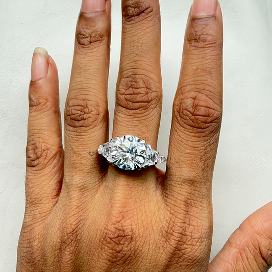 Impressive finger coverage and brilliance of multi-stone bullet and trapezoid diamond trilogy ring worn outdoors