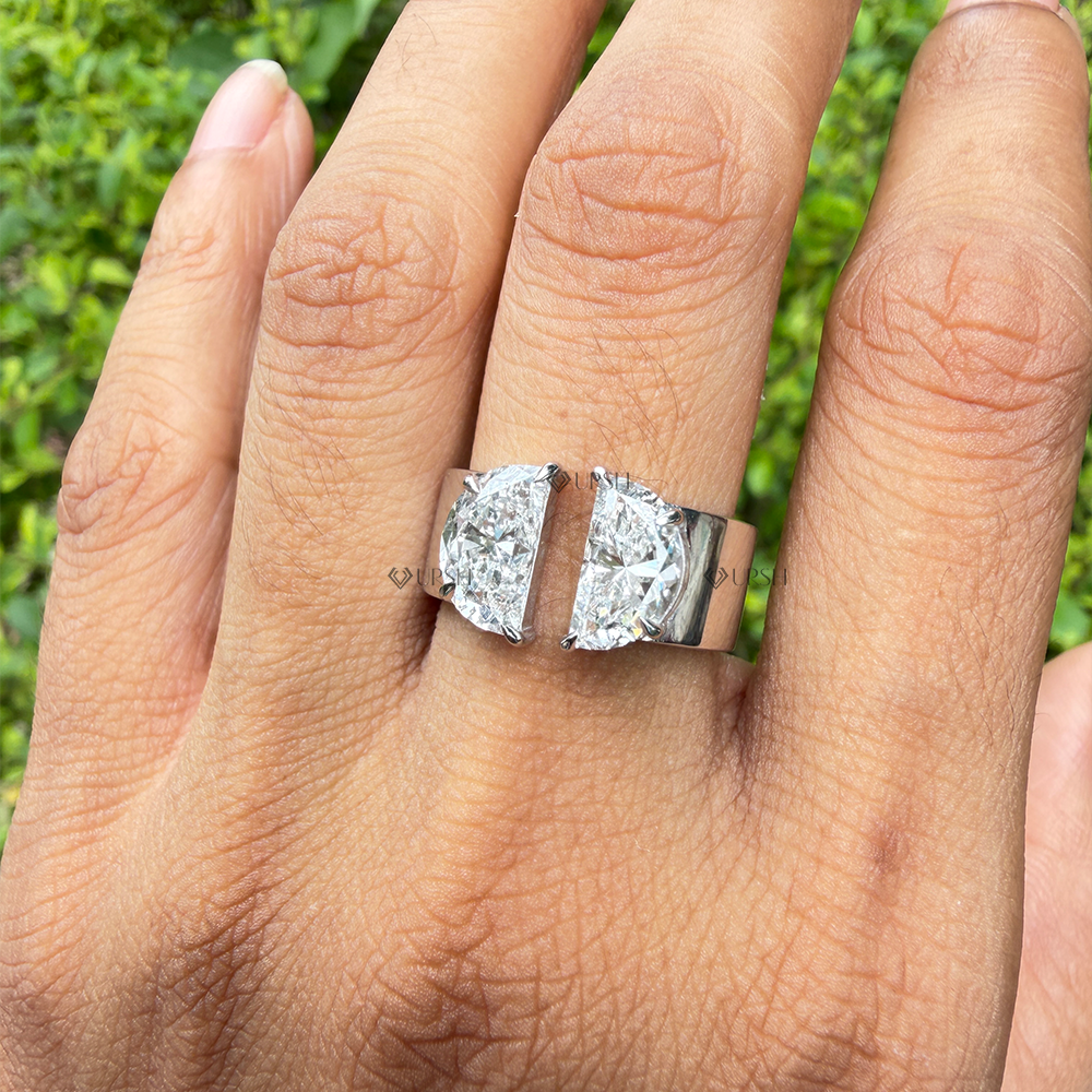Two stone half moon lab diamond open cuff ring worn on hand outdoors
