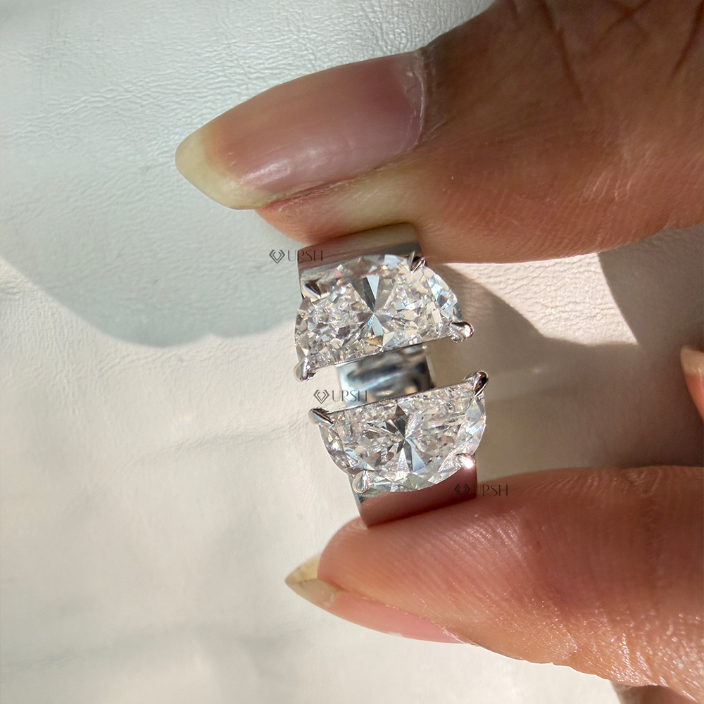 Holding white gold two-stone half moon open ring showing profile thickness and gap spacing