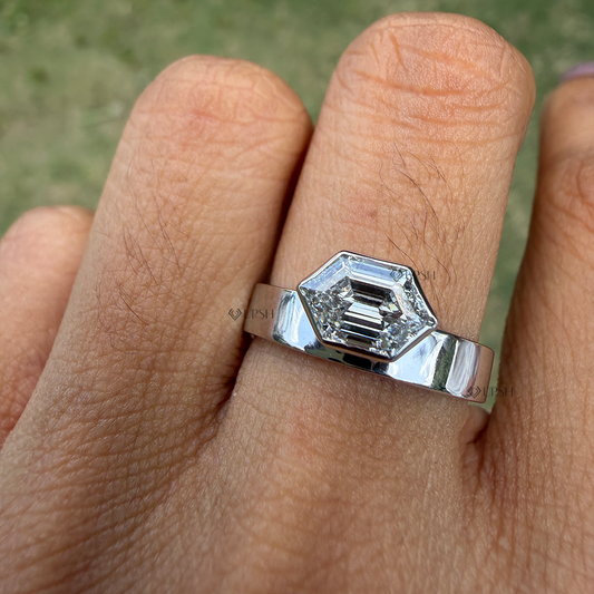Solid white gold flat cigar band ring featuring bezel set hexagon step cut lab grown diamond