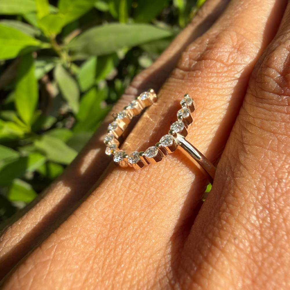 Side angle showing elevated U-shaped diamond halo arching over the finger