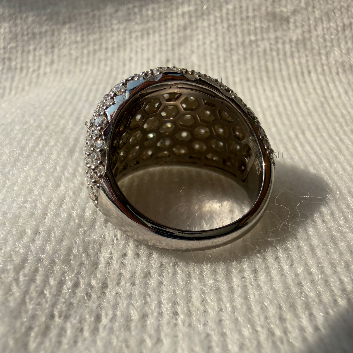 Under gallery view of a solid gold dome statement ring featuring a paved diamond exterior and an intricate honeycomb gallery design