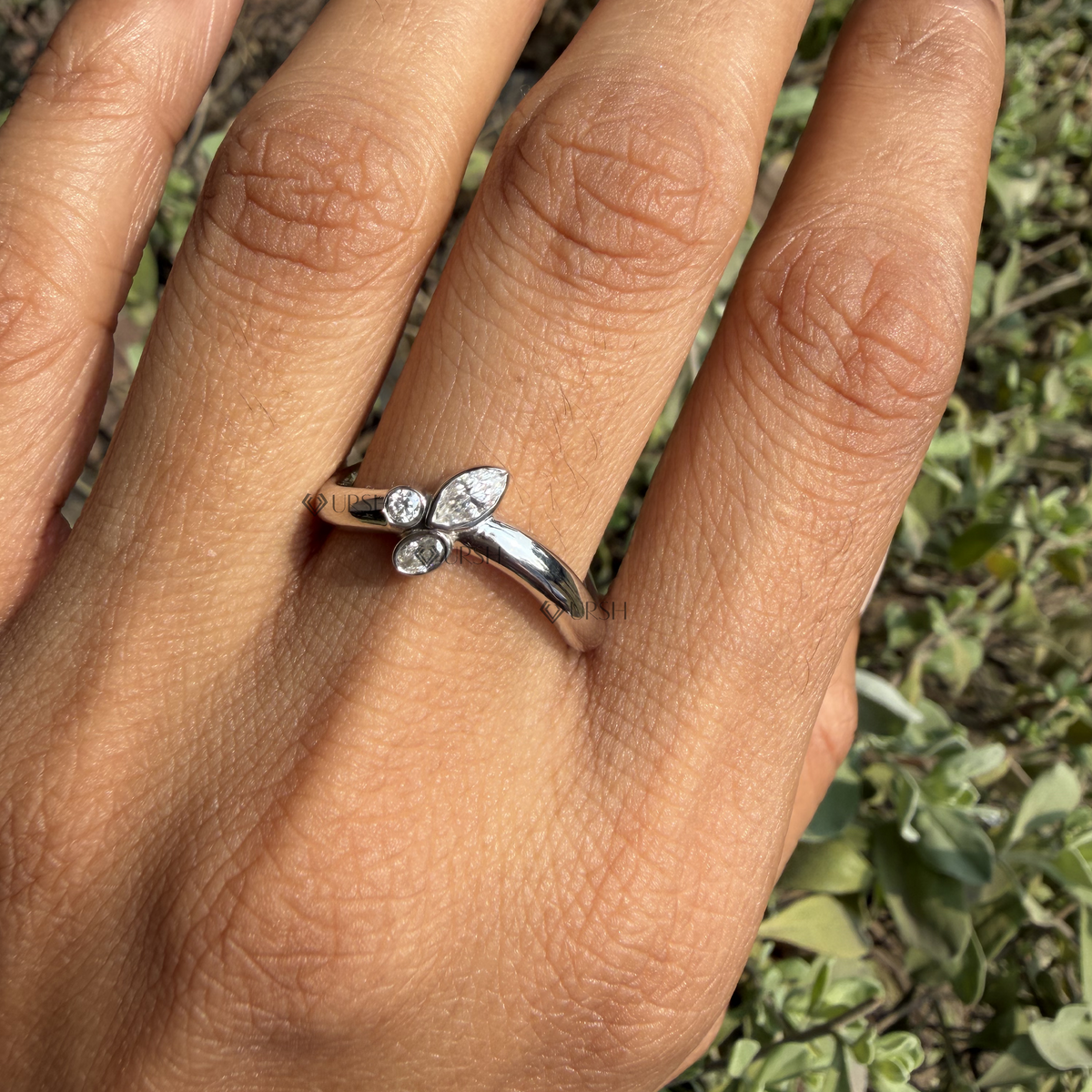 Daylight angle view of white gold contour diamond ring worn on hand showcasing V-shape silhouette