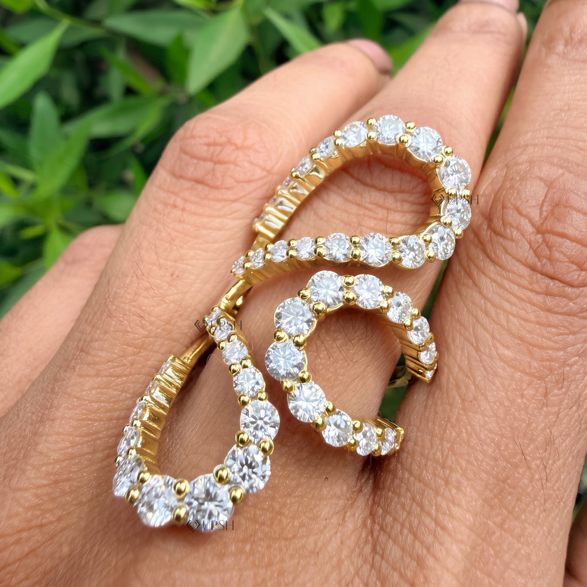 Daylight angle view of sculptural multi-finger pavé ring worn on hand showcasing bold runway volume