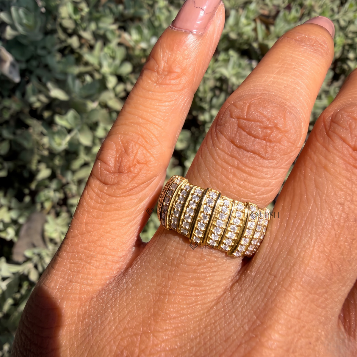 Chunky multi-row pavé barrel ring styled gracefully on finger in natural daylight
