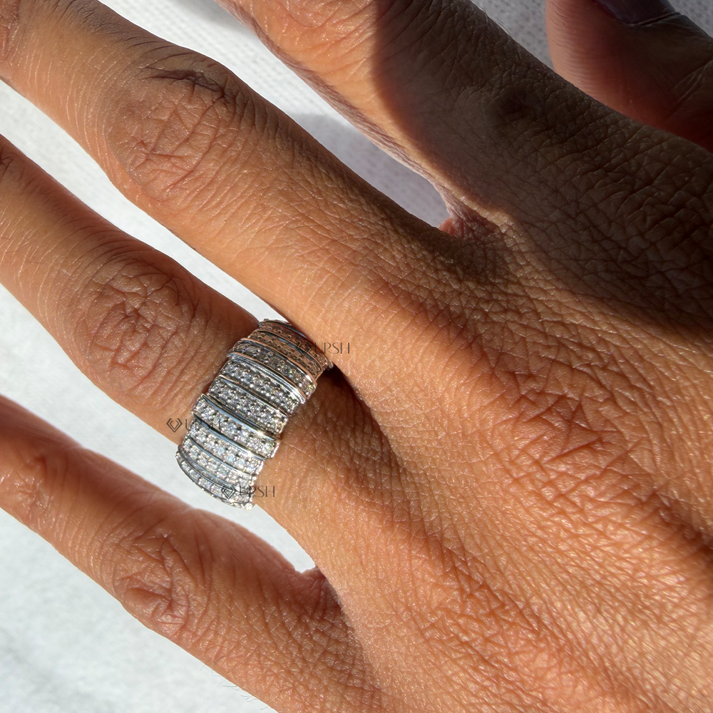 Striking wide multi-row pavé barrel ring worn on hand displaying high brilliance and architectural presence