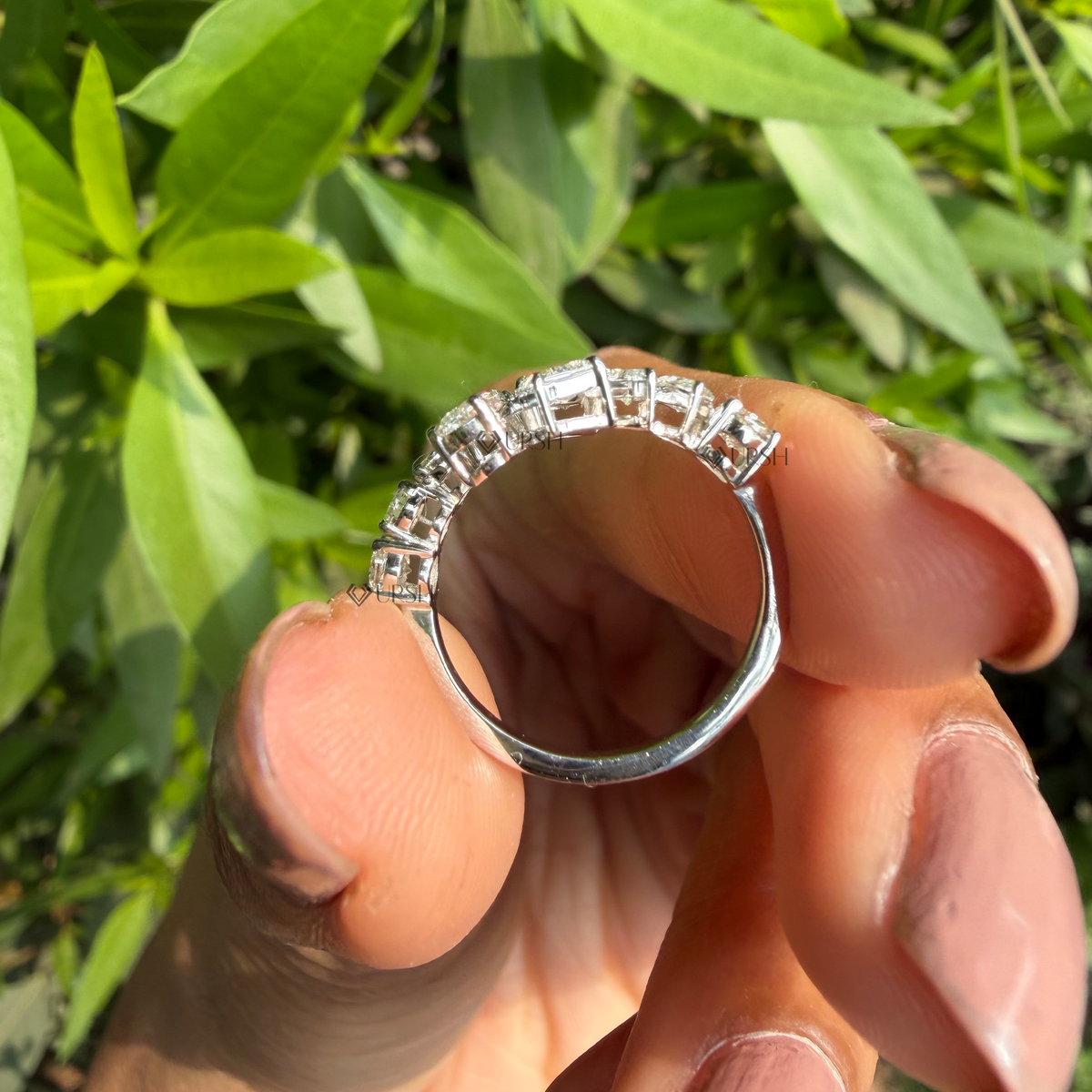 Detailed macro close-up view of prong-set mixed-cut multi-shape lab-grown diamonds along the inner profile of a solid white gold half eternity band