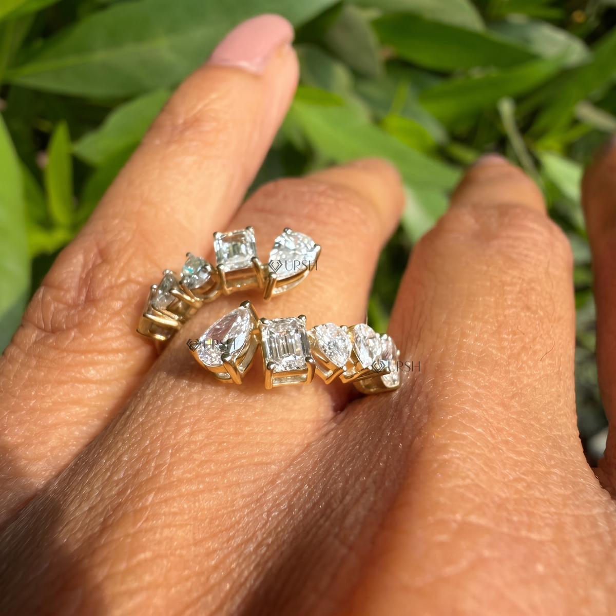 Multi-shape diamond bypass wrap ring styled gracefully on finger in natural daylight