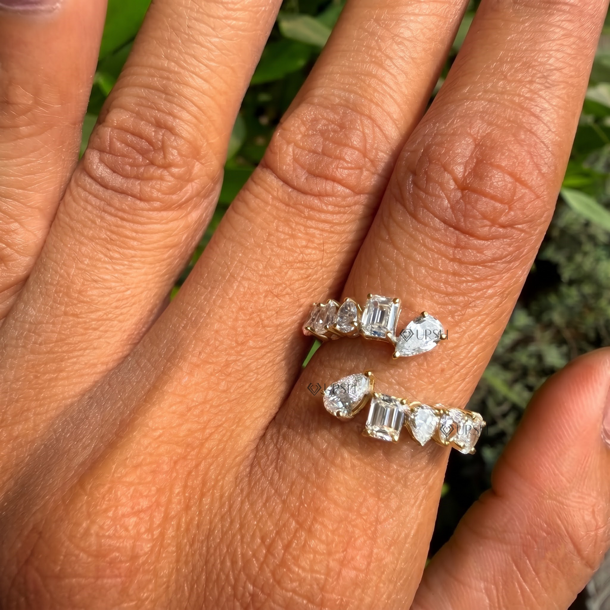 Daylight angle view of white gold multi-shape wrap ring worn on hand showcasing bypass silhouette