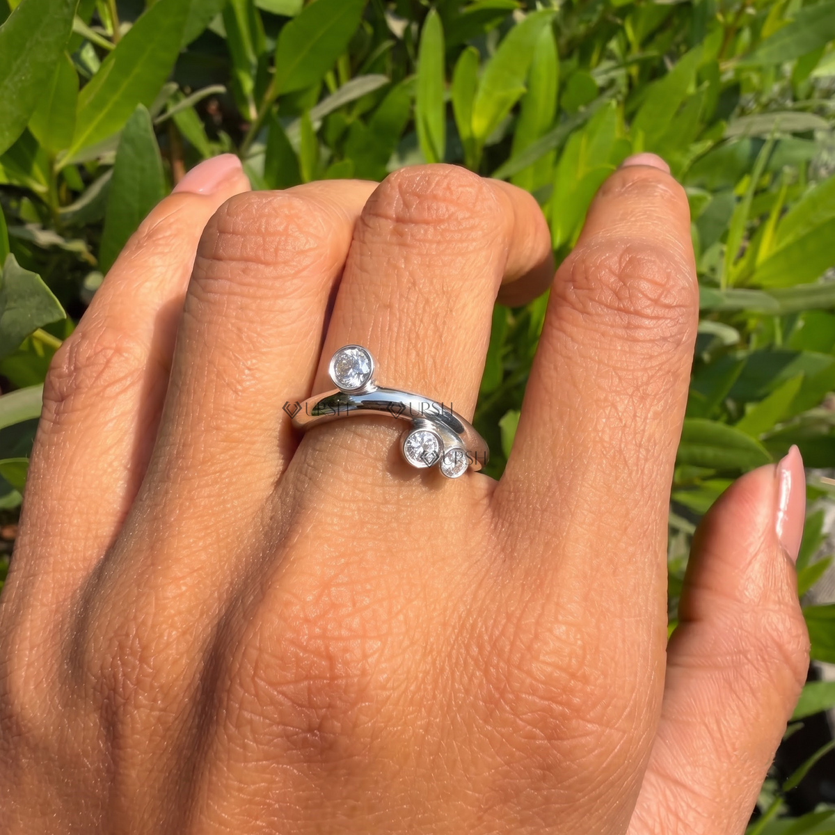 Daylight angle view of white gold scattered cluster ring worn on hand