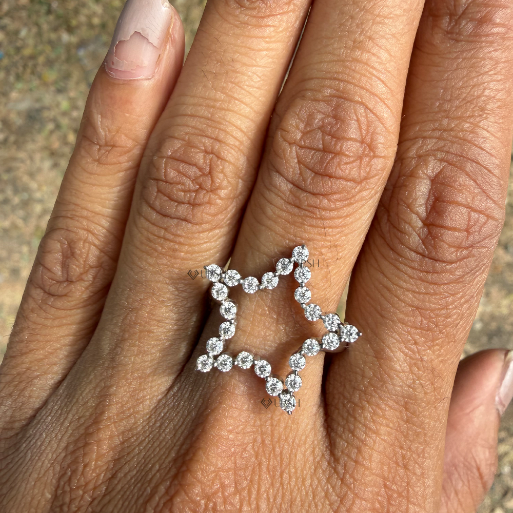White gold diamond star statement cocktail ring catching soft natural light on finger