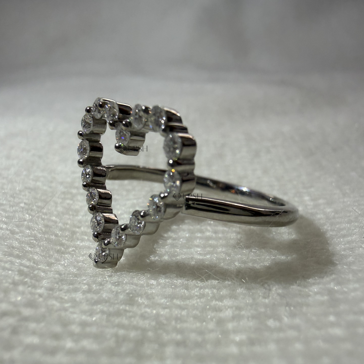 Side angle showing elevated open heart gallery and slim polished solid gold band