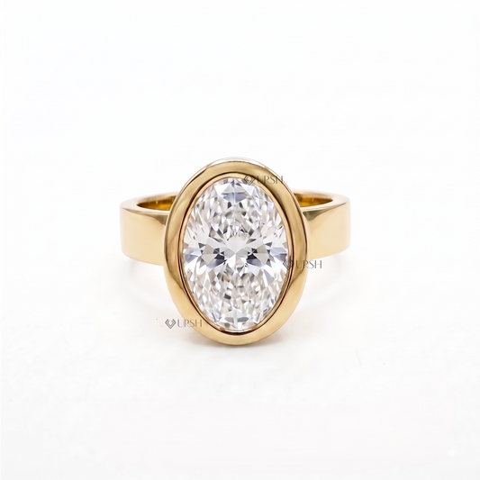 Solid yellow gold modern bezel solitaire engagement ring featuring large oval lab grown diamond