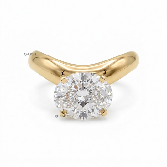 A yellow gold solitaire engagement ring featuring a round brilliant-cut diamond center stone in a four-prong setting, shown on a clean white background with a faint watermark.