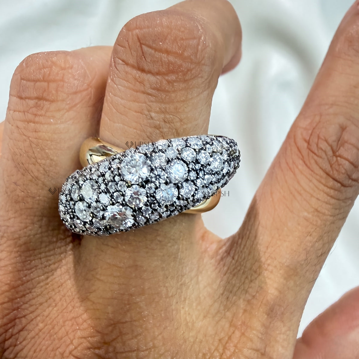 High finger presence of diagonal swell diamond cocktail ring worn on hand