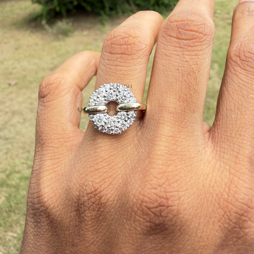 Detailed daylight view of the two-tone pavé disc cocktail ring styled gracefully on a hand against natural garden greenery.