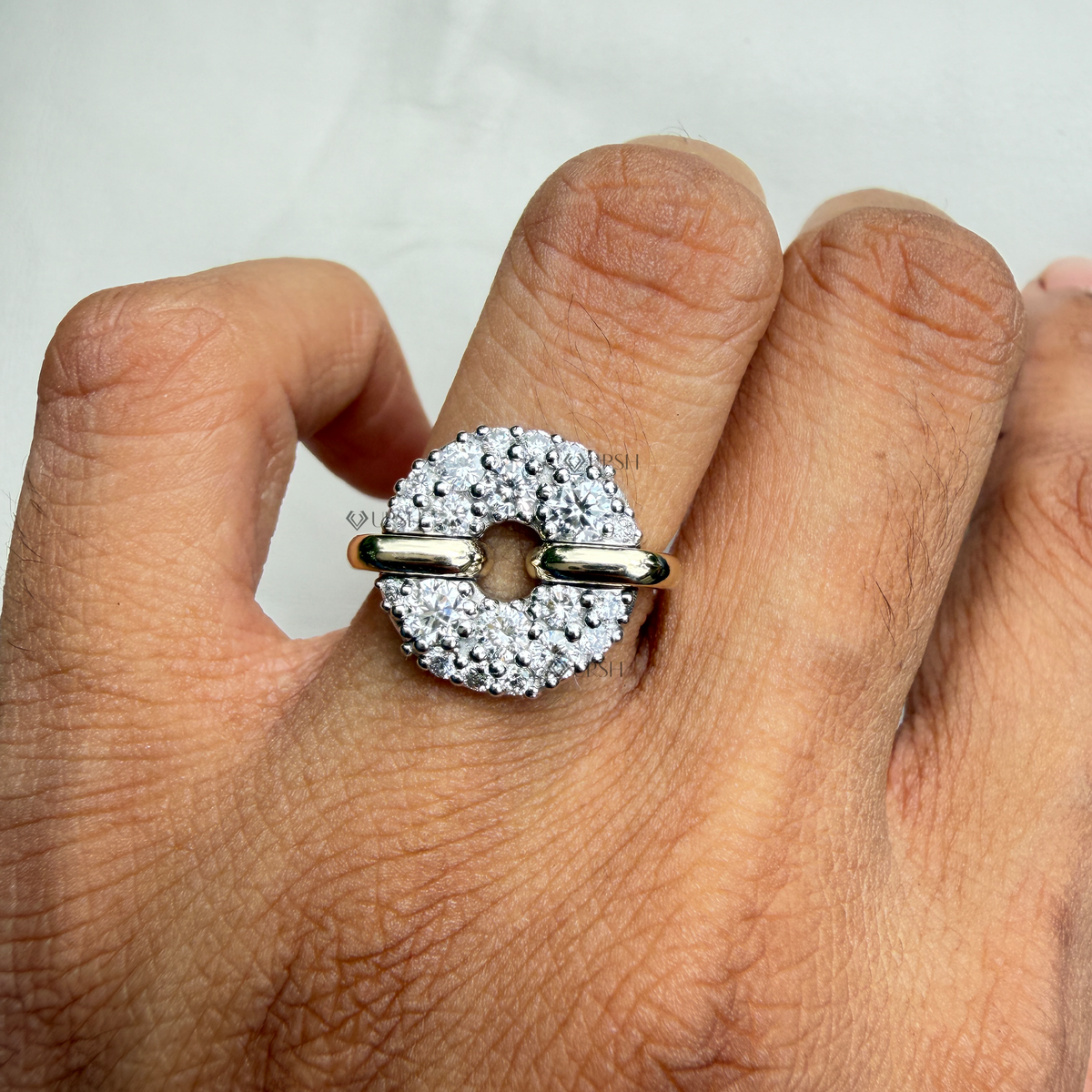 Close-up macro view of the two-tone pavé disc ring worn on a hand, emphasizing the precision of the micro-prong stone settings.