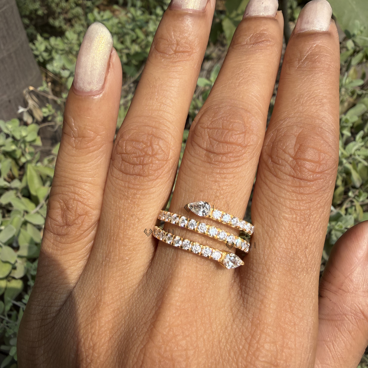 Close-up daylight view of coiled serpent ring displaying brilliant pavé tracks and custom proportions