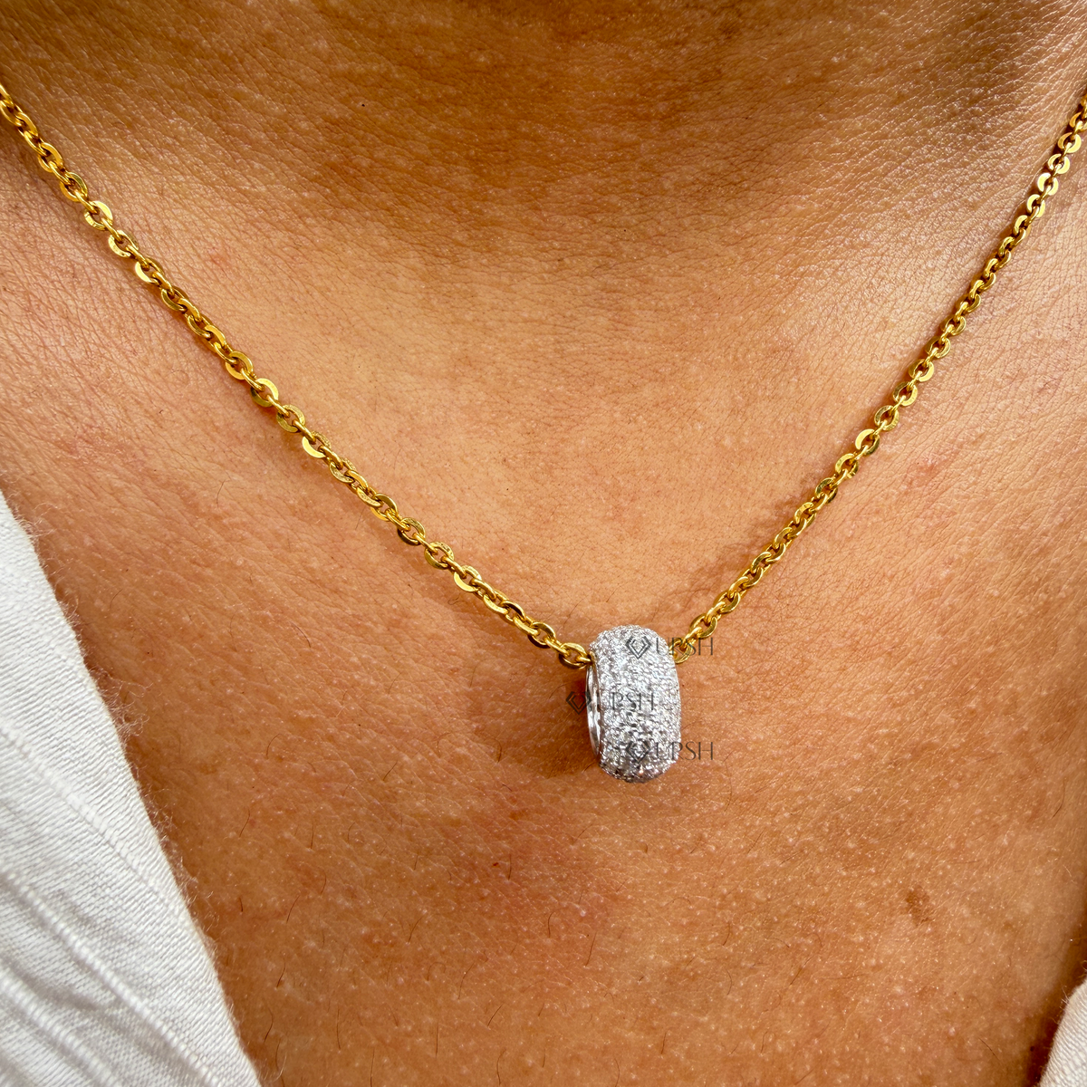 Yellow gold pavé diamond barrel bead spacer pendant necklace styled gracefully on neck in natural daylight