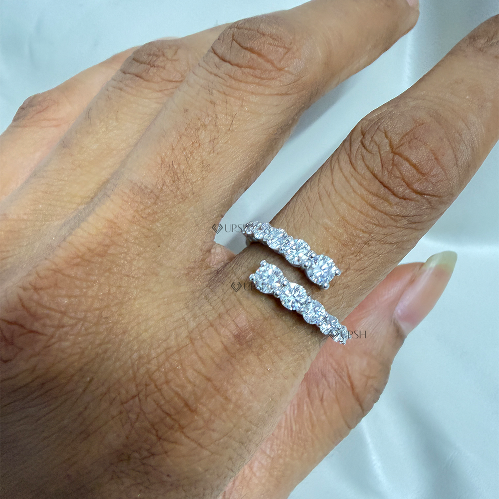 White gold diamond bypass wrap band catching light across the knuckles