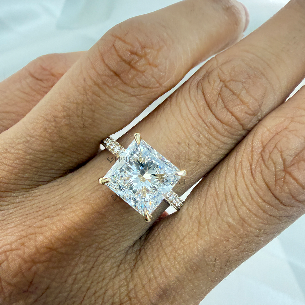Detailed daylight close-up of radiant cut lab diamond solitaire with pavé band worn on hand