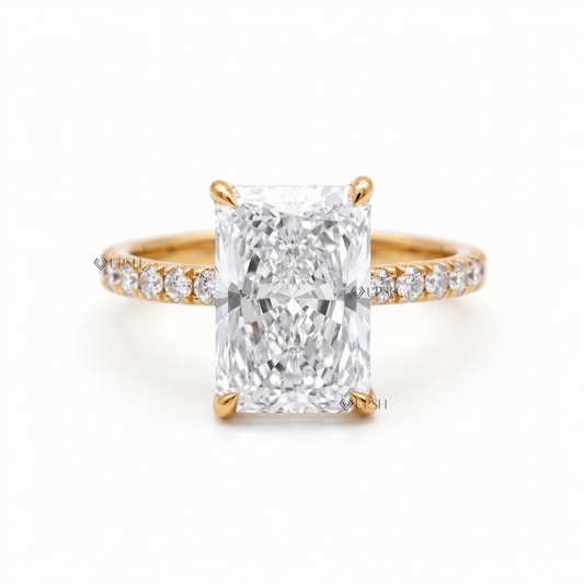 Solid yellow gold radiant cut solitaire engagement ring featuring a rectangular center diamond on a pavé band