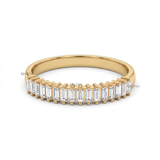 Solid yellow gold shared prong baguette diamond wedding ring on clean white backdrop