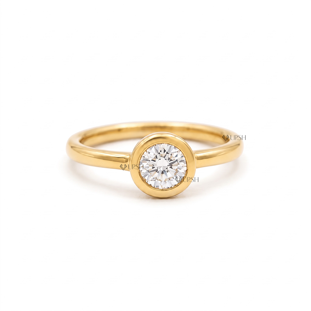 Solid yellow gold modern engagement ring featuring a round brilliant lab grown diamond in a smooth bezel setting