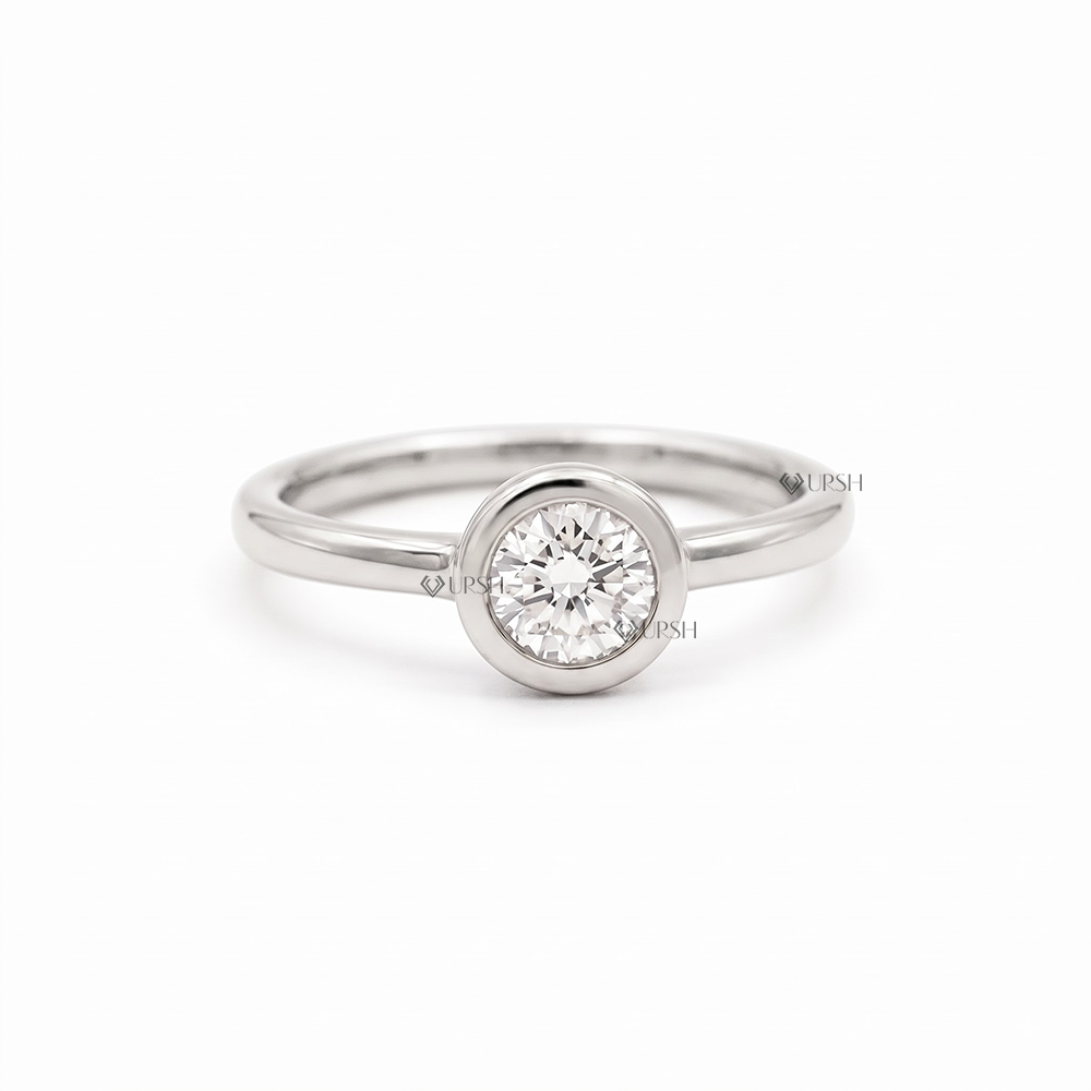 Solid white gold minimalist round diamond bezel solitaire ring on plain white background