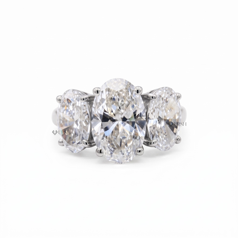 Solid white gold three-stone oval diamond ring with half-pave band on clean white background