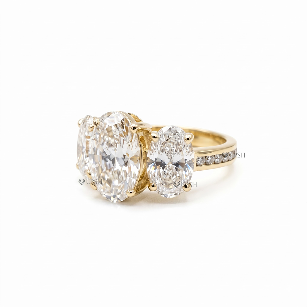 yellow gold three-stone oval lab diamond ring worn on finger showing impressive finger coverage