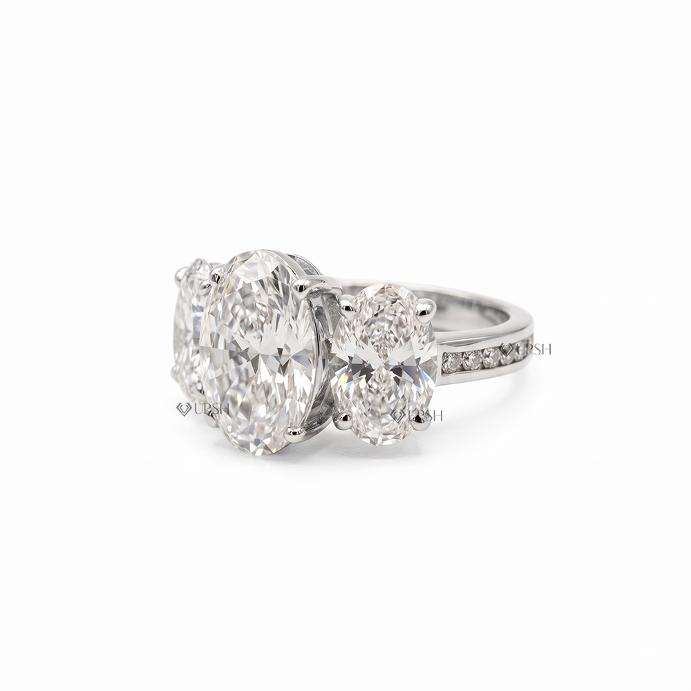 Studio view of white gold trilogy ring showcasing side oval proportions and polished shank