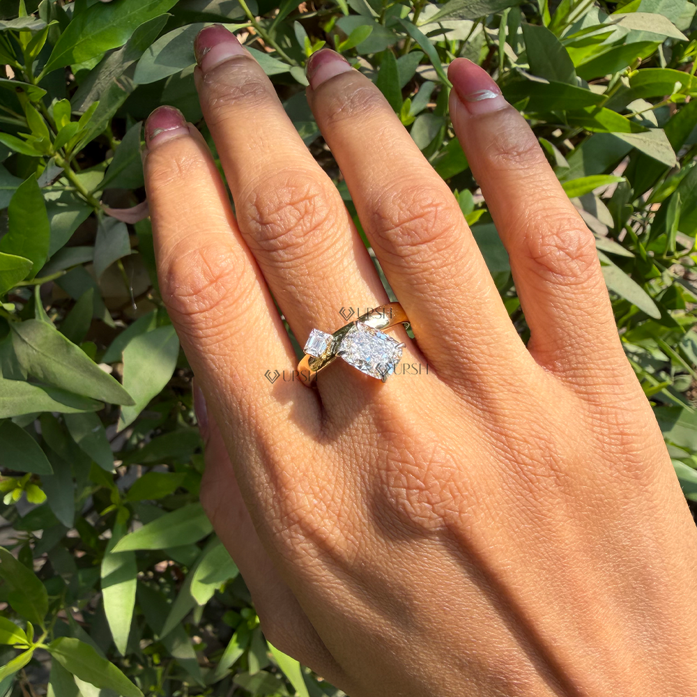Modern yellow gold Toi et Moi diamond statement ring worn on finger in natural outdoor light