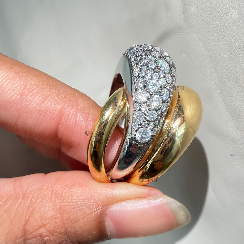 Side angle holding two-tone dome ring showcasing overlapping yellow gold bands and white gold diamond head