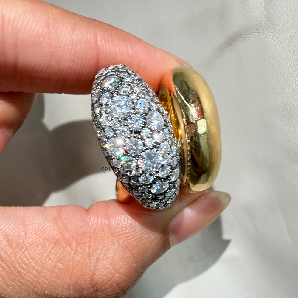 Close-up holding heavy two-tone gold statement ring highlighting brilliant diamond fire in natural sunlight