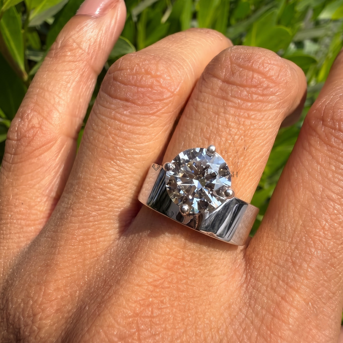 White gold wide statement cigar ring worn gracefully on hand in daylight