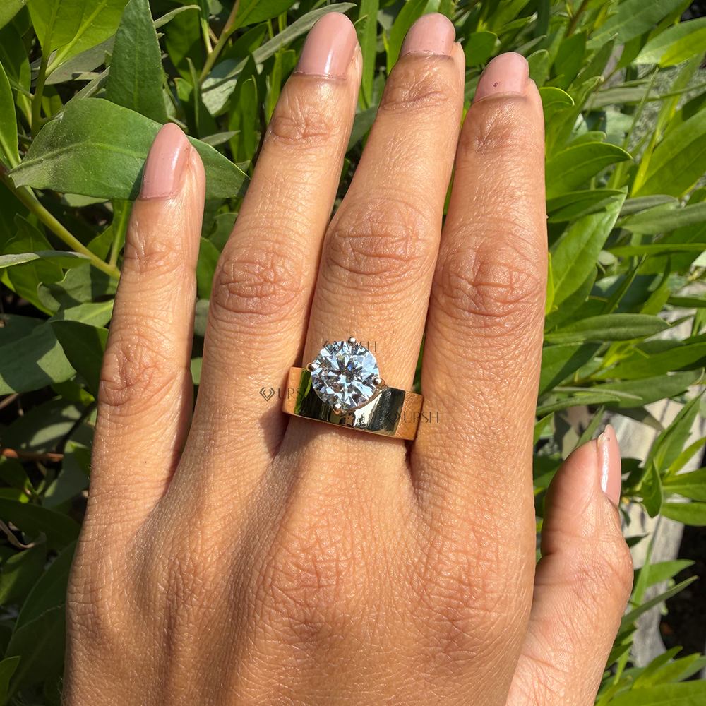 Substantial finger presence and high polish shine of wide yellow gold cigar band diamond ring