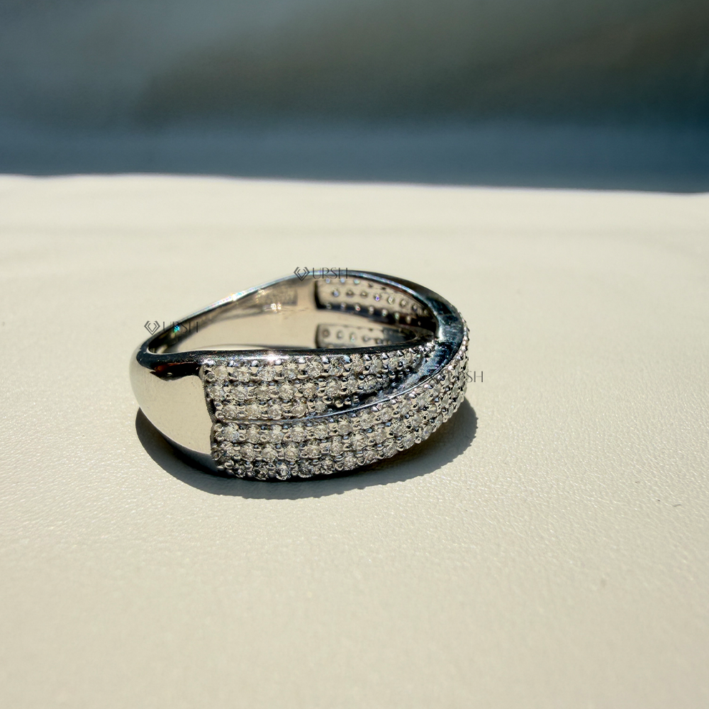 Detailed daylight macro close-up of multi-row micro-pavé intersecting tracks on wide criss-cross statement ring worn on finger