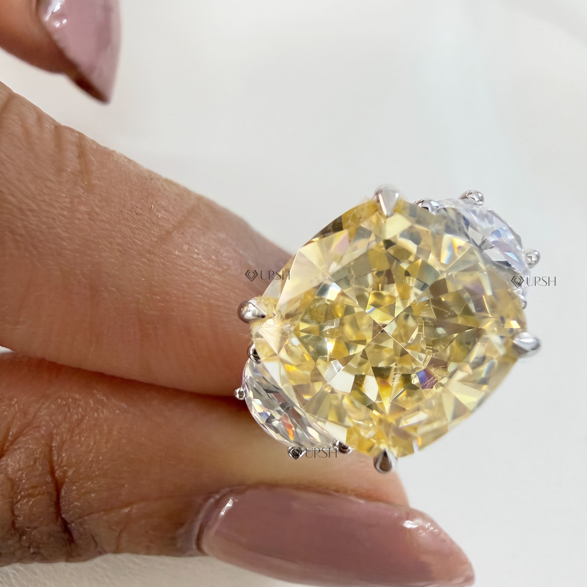 Natural light reflection on brilliant facets of fancy yellow cushion cut center lab diamond