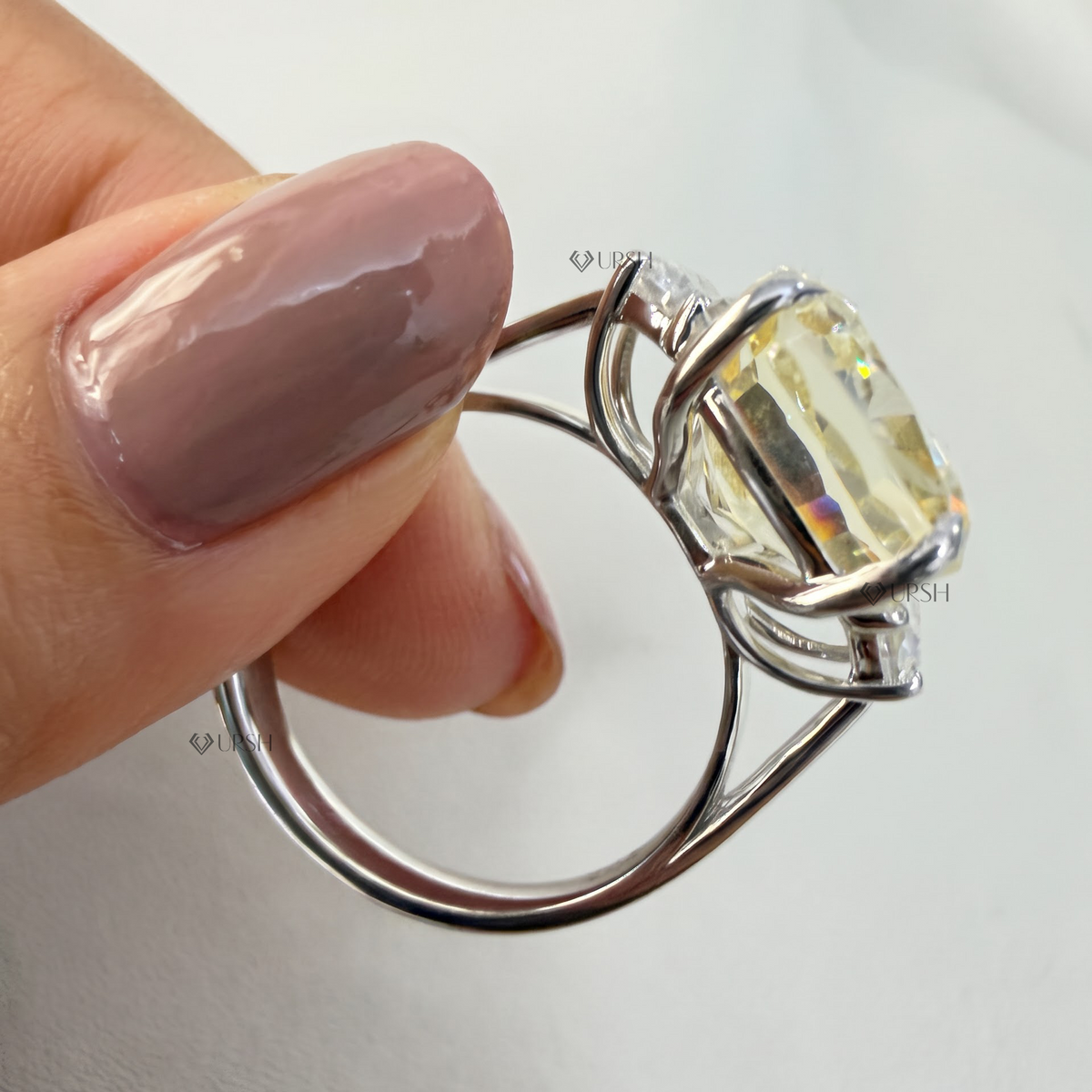 Side angle highlighting open gallery and multi-claw prong setting of canary diamond cocktail ring