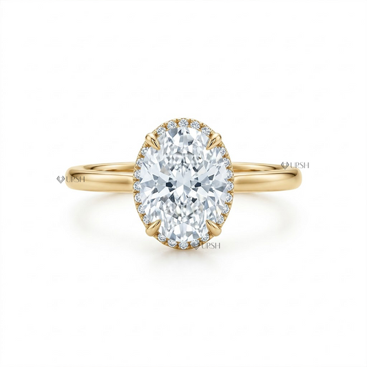 Solid yellow gold solitaire engagement ring featuring elongated oval lab grown diamond with hidden halo