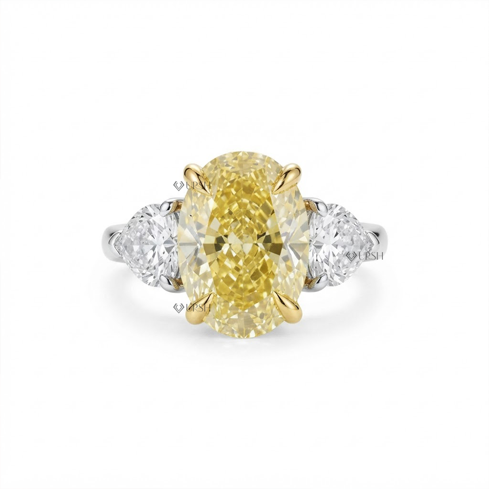Solid two-tone gold three-stone engagement ring featuring a vivid canary yellow oval lab diamond flanked by pear side stones