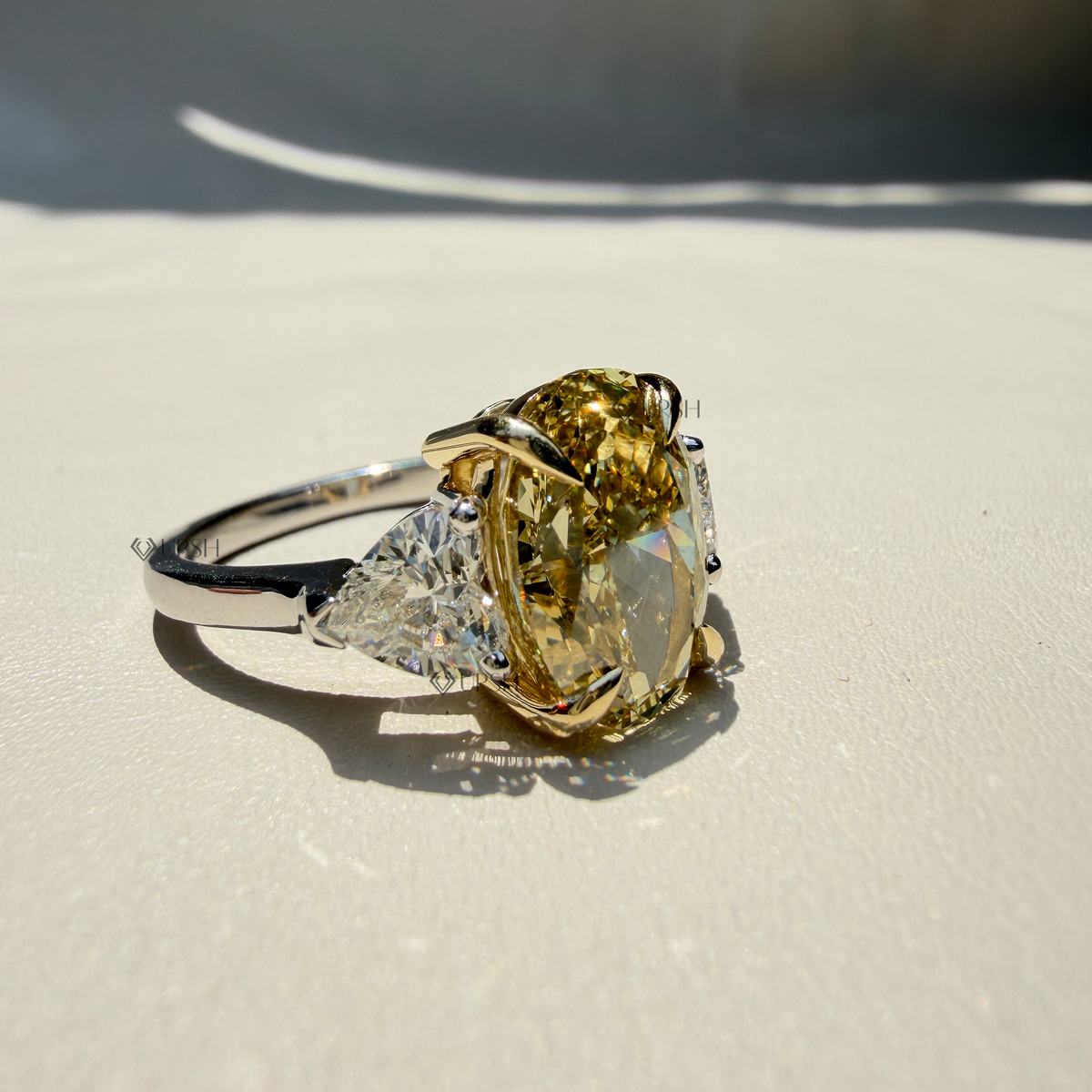 Studio angle of two-tone trilogy ring displaying polished shank and secure multi-stone basket