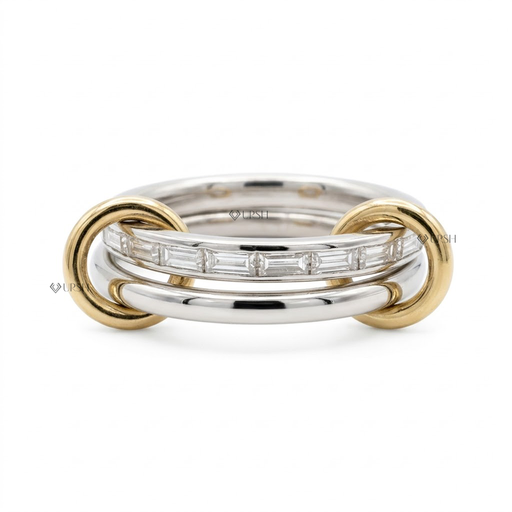 Solid two-tone gold interlocking statement ring featuring a channel of baguette diamonds linked by yellow gold end loops