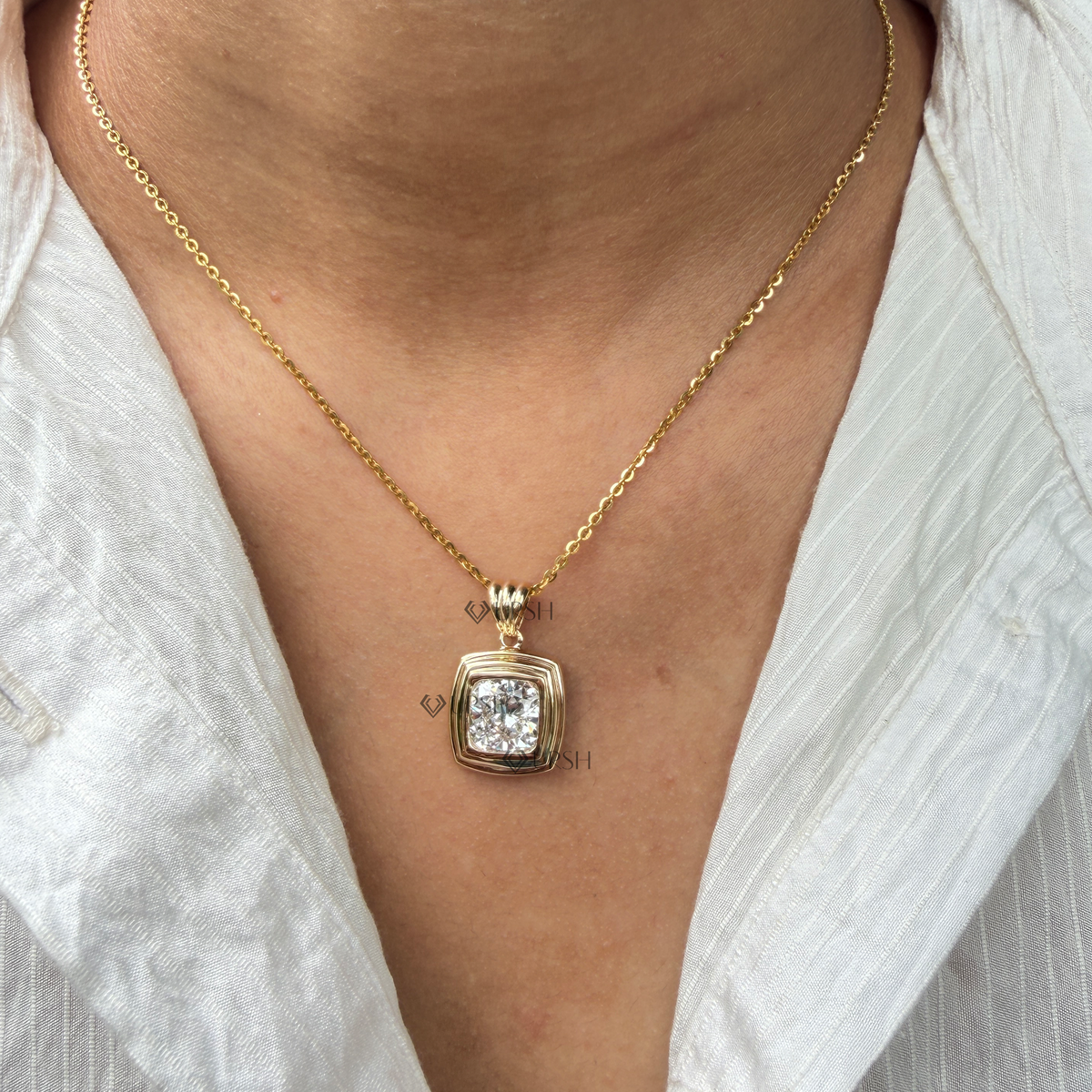 Daylight angle view of yellow gold cushion solitaire pendant chain worn along collarbone